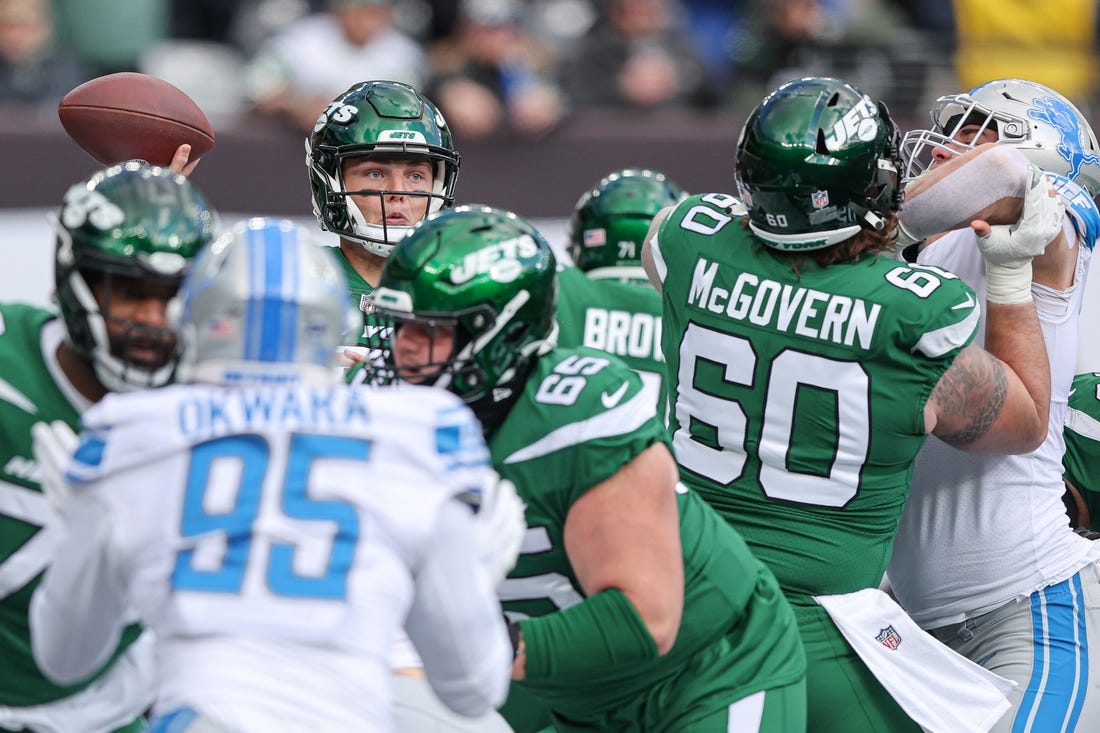 Dec 18, 2022; East Rutherford, New Jersey, USA; New York Jets quarterback Zach Wilson (2) throws the ball  as center Connor McGovern (60) blocks during the first quarter against the Detroit Lions at MetLife Stadium. Mandatory Credit: Vincent Carchietta-USA TODAY Sports