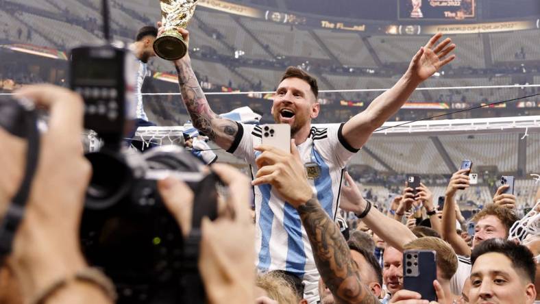 Dec 18, 2022; Lusail, Qatar; Argentina forward Lionel Messi (10) celebrates with fans after winning the 2022 World Cup final against France at Lusail Stadium. Mandatory Credit: Yukihito Taguchi-USA TODAY Sports