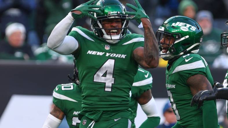 Dec 18, 2022; East Rutherford, New Jersey, USA; New York Jets cornerback D.J. Reed (4) celebrates a defensive stop against the Detroit Lions during the second half at MetLife Stadium. Mandatory Credit: Ed Mulholland-USA TODAY Sports