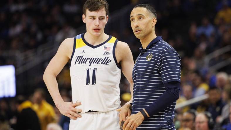 Dec 16, 2022; Milwaukee, Wisconsin, USA;  Marquette Golden Eagles head coach Shaka Smart talks with guard Tyler Kolek (11) during the game against the Creighton Bluejays at Fiserv Forum. Mandatory Credit: Jeff Hanisch-USA TODAY Sports