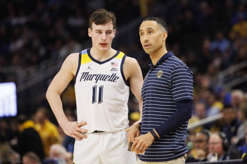 Dec 16, 2022; Milwaukee, Wisconsin, USA;  Marquette Golden Eagles head coach Shaka Smart talks with guard Tyler Kolek (11) during the game against the Creighton Bluejays at Fiserv Forum. Mandatory Credit: Jeff Hanisch-USA TODAY Sports