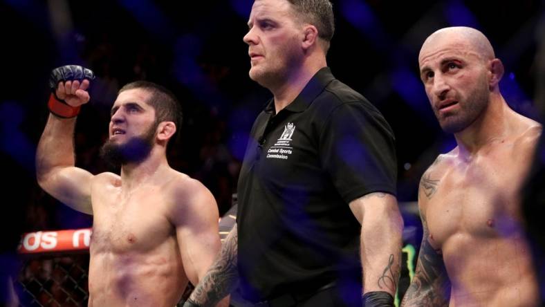 Feb 12, 2023; Perth, WA, AUSTRALIA; Islam Makhachev (red gloves) celebrates after defeating Alexander Volkanovski (blue gloves) for the lightweight championship during UFC 284 at RAC Arena. Mandatory Credit: Jasmin Frank-USA TODAY Sports