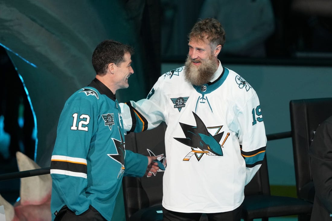 Feb 25, 2023; San Jose, California, USA; San Jose Sharks former player Patrick Marleau talks to former player Joe Thornton during his jersey retirement ceremony before the game against the Chicago Blackhawks at SAP Center at San Jose. Mandatory Credit: Darren Yamashita-USA TODAY Sports