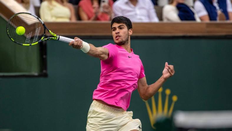 Carlos Alcaraz of Spain hits to Daniil Medvedev of Russia during the men's singles final at the BNP Paribas Open of the Indian Wells Tennis Garden in Indian Wells, Calif., Sunday, March 19, 2023.