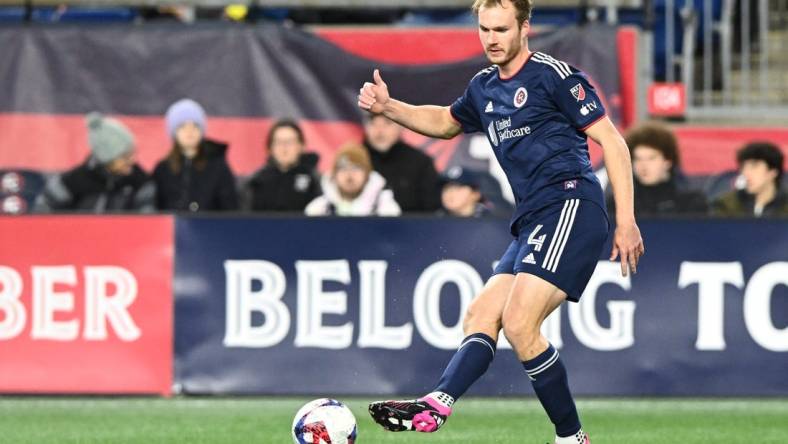 Mar 18, 2023; Foxborough, Massachusetts, USA; New England Revolution defender Henry Kessler (4) kicks the ball against the Nashville SC during the first half at Gillette Stadium. Mandatory Credit: Brian Fluharty-USA TODAY Sports