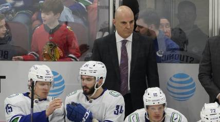 Mar 26, 2023; Chicago, Illinois, USA; Vancouver Canucks head coach Rick Tocchet stands behind the bench during the first period at United Center. Mandatory Credit: David Banks-USA TODAY Sports
