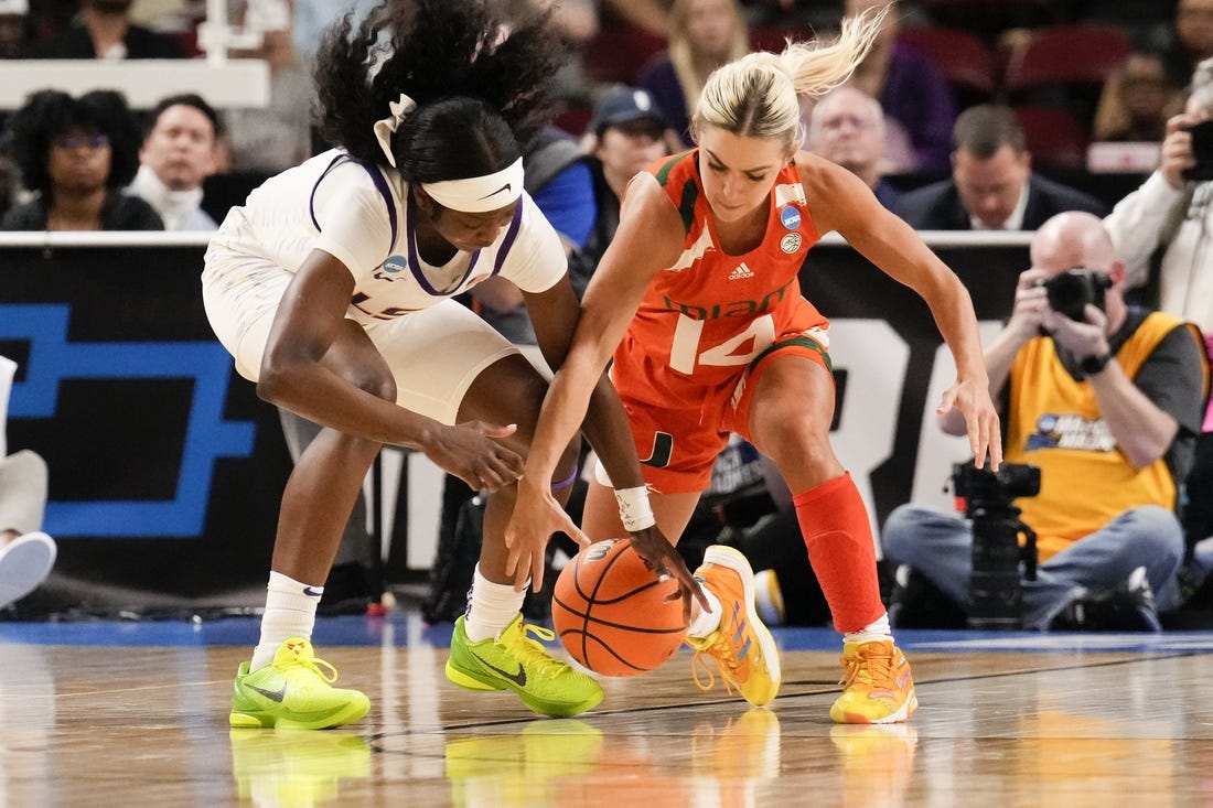 Mar 26, 2023; Greenville, SC, USA; LSU Lady Tigers guard Alexis Morris (45) and Miami Hurricanes guard Haley Cavinder (14) chase the loose ball during the second half in the NCAA Women   s Tournament at Bon Secours Wellness Arena. Mandatory Credit: Jim Dedmon-USA TODAY Sports