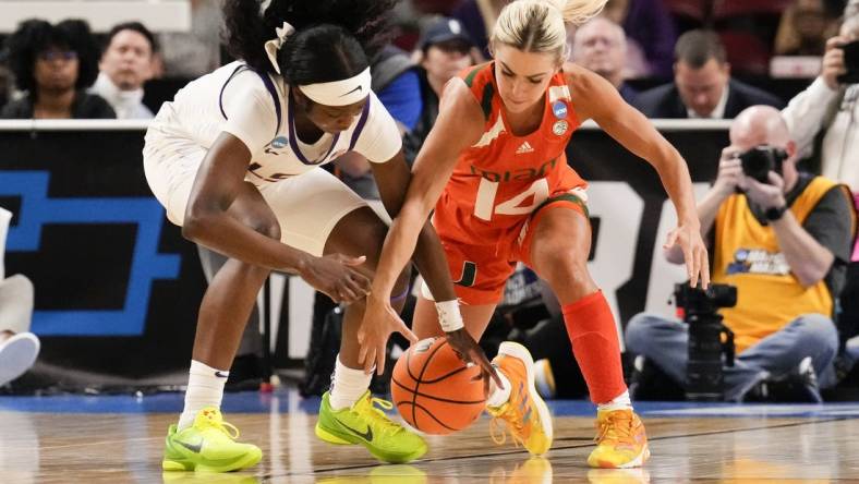 Mar 26, 2023; Greenville, SC, USA; LSU Lady Tigers guard Alexis Morris (45) and Miami Hurricanes guard Haley Cavinder (14) chase the loose ball during the second half in the NCAA Women   s Tournament at Bon Secours Wellness Arena. Mandatory Credit: Jim Dedmon-USA TODAY Sports