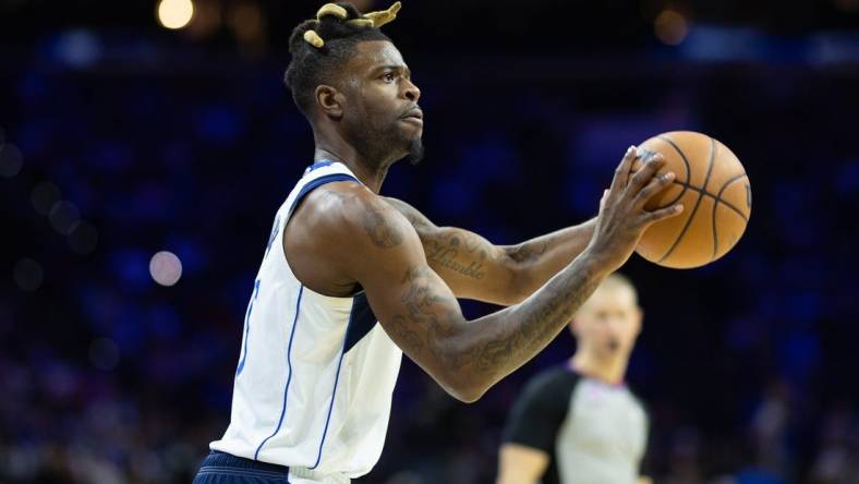 Mar 29, 2023; Philadelphia, Pennsylvania, USA; Dallas Mavericks forward Reggie Bullock (25) shoots the ball against the Philadelphia 76ers during the second quarter at Wells Fargo Center. Mandatory Credit: Bill Streicher-USA TODAY Sports