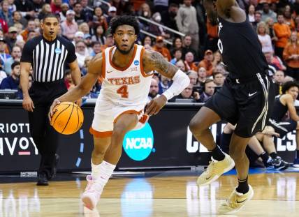 Mar 24, 2023; Kansas City, MO, USA; Texas Longhorns guard Tyrese Hunter (4) dribbles the ball against Xavier Musketeers guard Souley Boum (0) during the first half of an NCAA tournament Midwest Regional semifinal at T-Mobile Center. Mandatory Credit: Jay Biggerstaff-USA TODAY Sports