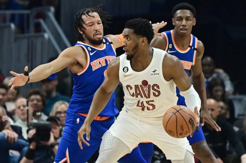 Mar 31, 2023; Cleveland, Ohio, USA; Cleveland Cavaliers guard Donovan Mitchell (45) is defended by New York Knicks guard Jalen Brunson (11) during the first half at Rocket Mortgage FieldHouse. Mandatory Credit: Ken Blaze-USA TODAY Sports