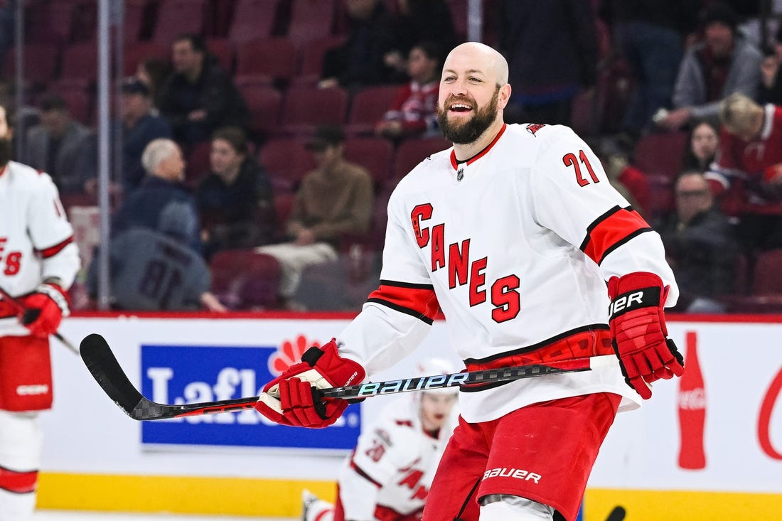 Apr 1, 2023; Montreal, Quebec, CAN; Carolina Hurricanes center Derek Stepan (21) smiles while looking at his teammates during warm-up before the game against the Montreal Canadiens at Bell Centre. Mandatory Credit: David Kirouac-USA TODAY Sports