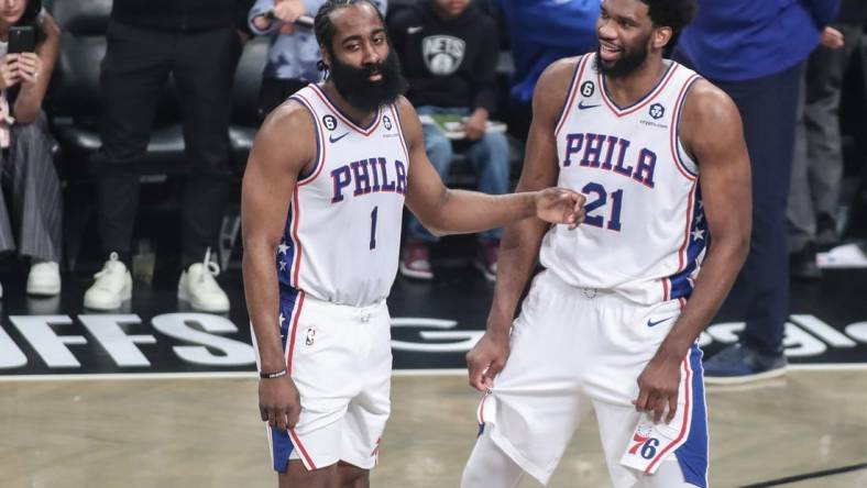 Apr 20, 2023; Brooklyn, New York, USA; Philadelphia 76ers guard James Harden (1) talks with center Joel Embiid (21) during an official   s review during game three of the 2023 NBA playoffs against the Brooklyn Nets at Barclays Center. Mandatory Credit: Wendell Cruz-USA TODAY Sports