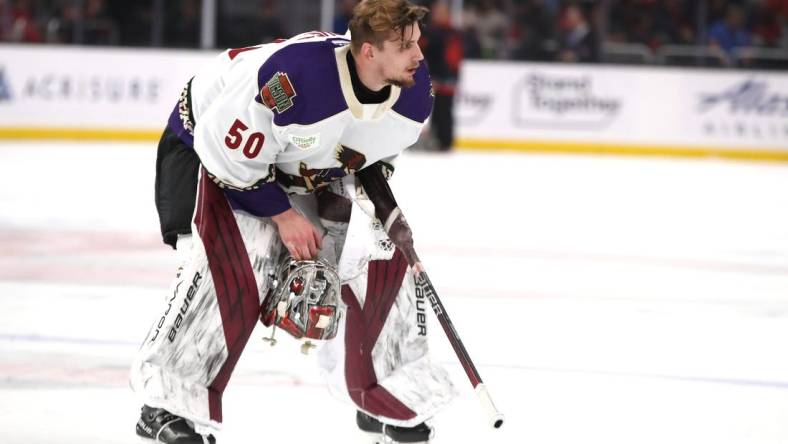 Tucson Roadrunners goalie Ivan Prosvetov (50) removes his helmet during a brief stop in play against the Coachella Valley Firebirds at Acrisure Arena in Palm Desert, Calif., on Friday, April 21, 2023.

Firebirds Vs Roadrunners Game 1 Calder Cup Playoffs6068