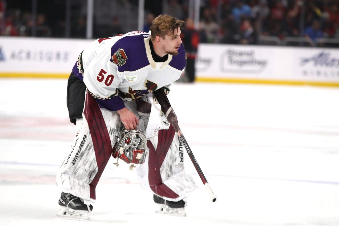 Tucson Roadrunners goalie Ivan Prosvetov (50) removes his helmet during a brief stop in play against the Coachella Valley Firebirds at Acrisure Arena in Palm Desert, Calif., on Friday, April 21, 2023.

Firebirds Vs Roadrunners Game 1 Calder Cup Playoffs6068