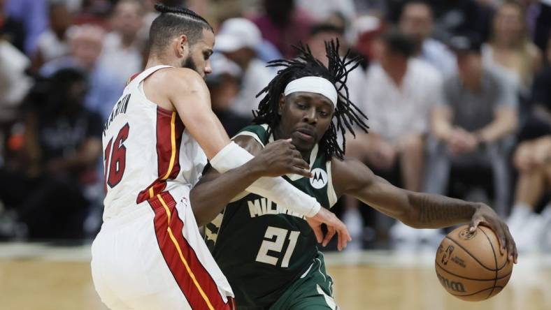 Apr 22, 2023; Miami, Florida, USA; Milwaukee Bucks guard Jrue Holiday (21) drives to the basket against Miami Heat forward Caleb Martin (16) in the third quarter during game three of the 2023 NBA Playoffs at Kaseya Center. Mandatory Credit: Sam Navarro-USA TODAY Sports