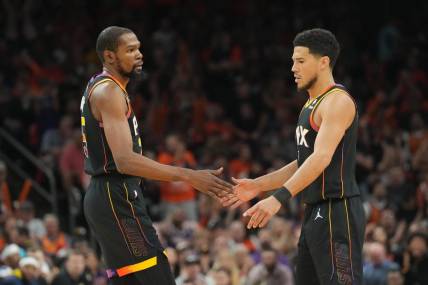 May 11, 2023; Phoenix, Arizona, USA; Phoenix Suns forward Kevin Durant (35) and Phoenix Suns guard Devin Booker (1) slap hands during the first half of game six of the 2023 NBA playoffs against the Denver Nuggets at Footprint Center. Mandatory Credit: Joe Camporeale-USA TODAY Sports