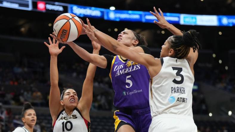 May 25, 2023; Los Angeles, California, USA; LA Sparks guard Dearica Hamby (5) shoots the ball against Las Vegas Aces forward Candace Parker (3) and guard Kelsey Plum (10) during the first half at Crypto.com Arena. Mandatory Credit: Kirby Lee-USA TODAY Sports