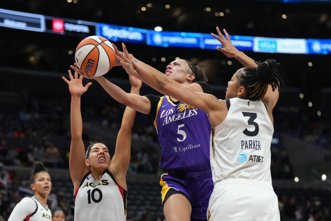 May 25, 2023; Los Angeles, California, USA; LA Sparks guard Dearica Hamby (5) shoots the ball against Las Vegas Aces forward Candace Parker (3) and guard Kelsey Plum (10) during the first half at Crypto.com Arena. Mandatory Credit: Kirby Lee-USA TODAY Sports