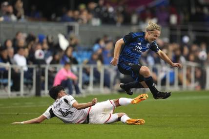 May 27, 2023; San Jose, California, USA; San Jose Earthquakes forward Tommy Thompson (right) leaps after a tackle by FC Dallas defender Marco Farfan (4) during the second half at PayPal Park. Mandatory Credit: Darren Yamashita-USA TODAY Sports