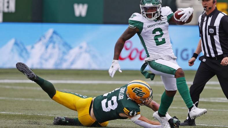 Jun 11, 2023; Edmonton, Alberta, CAN; Saskatchewan Roughriders wide receiver Mario Alford (2) makes a catch against Edmonton Elks linebacker Jake Taylor (13) during the first quarter at Commonwealth Stadium. Mandatory Credit: Perry Nelson-USA TODAY Sports