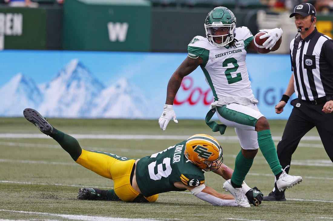 Jun 11, 2023; Edmonton, Alberta, CAN; Saskatchewan Roughriders wide receiver Mario Alford (2) makes a catch against Edmonton Elks linebacker Jake Taylor (13) during the first quarter at Commonwealth Stadium. Mandatory Credit: Perry Nelson-USA TODAY Sports