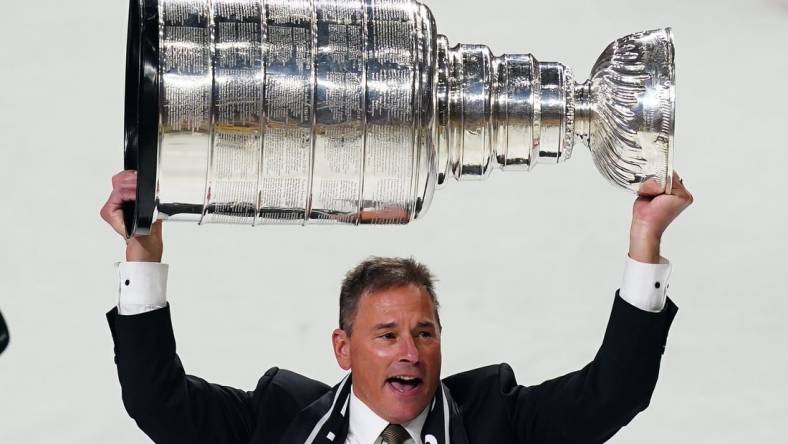 Jun 13, 2023; Las Vegas, Nevada, USA; Vegas Golden Knights head coach Bruce Cassidy hoists the Stanley Cup after defeating the Florida Panthers in game five of the 2023 Stanley Cup Final at T-Mobile Arena. Mandatory Credit: Lucas Peltier-USA TODAY Sports