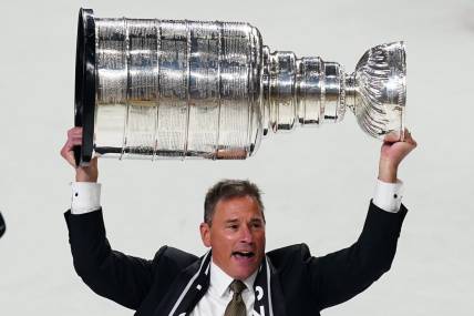 Jun 13, 2023; Las Vegas, Nevada, USA; Vegas Golden Knights head coach Bruce Cassidy hoists the Stanley Cup after defeating the Florida Panthers in game five of the 2023 Stanley Cup Final at T-Mobile Arena. Mandatory Credit: Lucas Peltier-USA TODAY Sports