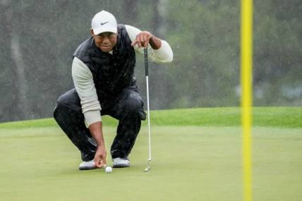 Tiger Woods lines up his putt on the 18th green during the second round of The Masters in April.