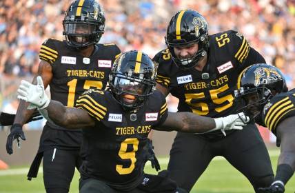 Jun 18, 2023; Toronto, Ontario, CAN;  Hamilton Tiger-Cats quarter James Butler (9) celebrates with teammates after scoring a touchdown against the Toronto Argonauts in the second quarter at BMO Field. Mandatory Credit: Dan Hamilton-USA TODAY Sports