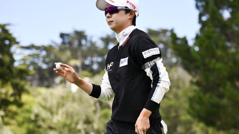 Jul 9, 2023; Pebble Beach, California, USA; Hyo Joo Kim acknowledges the crowd after her putt on the second hole  during the final round of the U.S. Women's Open golf tournament at Pebble Beach Golf Links. Mandatory Credit: Kelvin Kuo-USA TODAY Sports