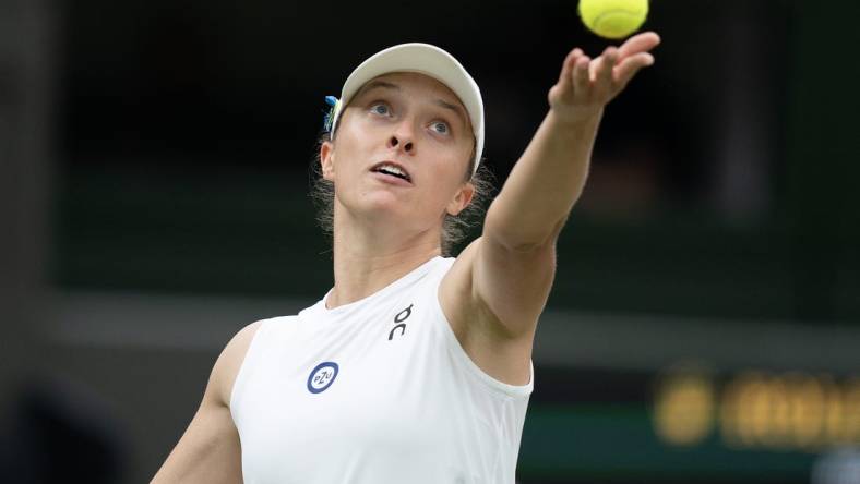 Jul 11, 2023; London, United Kingdom; Iga Swiatek (POL) tosses the ball to serve during her match against Elina Svitolina (UKR) on day nine of Wimbledon at the All England Lawn Tennis and Croquet Club.  Mandatory Credit: Susan Mullane-USA TODAY Sports