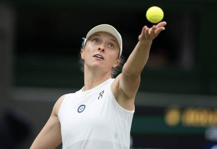 Jul 11, 2023; London, United Kingdom; Iga Swiatek (POL) tosses the ball to serve during her match against Elina Svitolina (UKR) on day nine of Wimbledon at the All England Lawn Tennis and Croquet Club.  Mandatory Credit: Susan Mullane-USA TODAY Sports