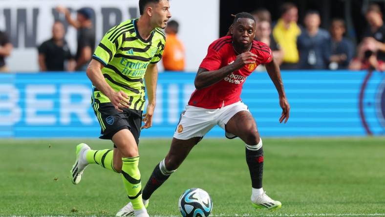 Jul 22, 2023; East Rutherford, New Jersey, USA; Arsenal forward Gabriel Martinelli (11) controls the ball in front of Manchester United defender Aaron Wan-Bissaka (29) during the first half at MetLife Stadium. Mandatory Credit: Vincent Carchietta-USA TODAY Sports