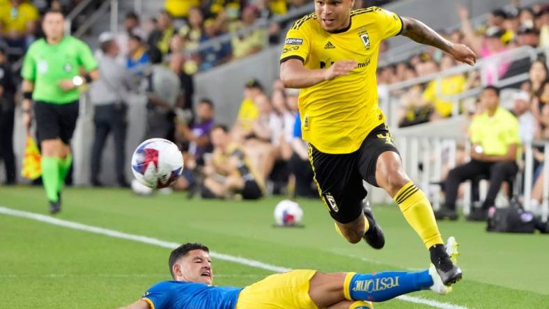 Jul 31, 2023; Columbus, OH, USA; Columbus Crew forward Cucho Hernandez (9) gets around the sliding tackle of Club America midfielder Richard Sanchez (20) during the first half of the League Cup group match at Lower.com Field.