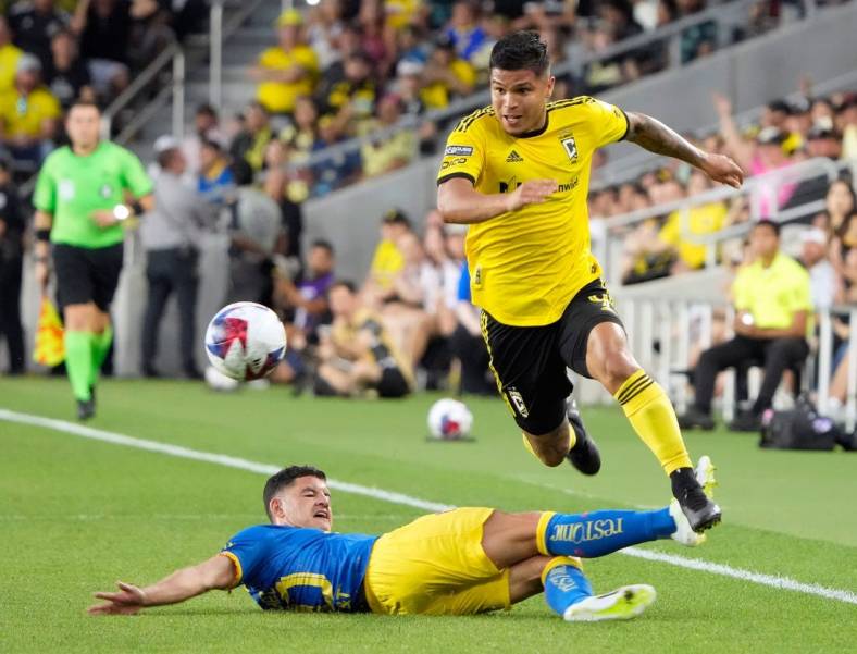 Jul 31, 2023; Columbus, OH, USA; Columbus Crew forward Cucho Hernandez (9) gets around the sliding tackle of Club America midfielder Richard Sanchez (20) during the first half of the League Cup group match at Lower.com Field.