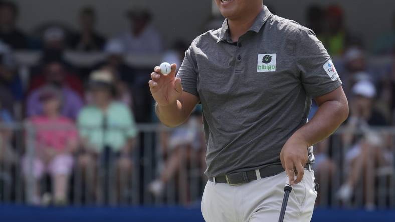 Aug 6, 2023; Greensboro, North Carolina, USA; Byeong Hun An shows the ball after a birdie on the 9th green during the final round of the Wyndham Championship golf tournament. Mandatory Credit: David Yeazell-USA TODAY Sports