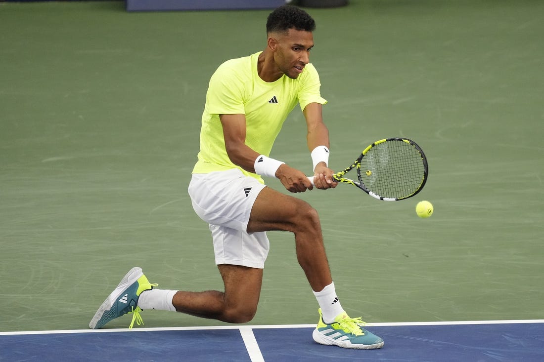 Aug 8, 2023; Toronto, Ontario, Canada; Felix Auger-Aliassime (CAN) hits a ball to Max Purcell (not pictured) at Sobeys Stadium. Mandatory Credit: John E. Sokolowski-USA TODAY Sports