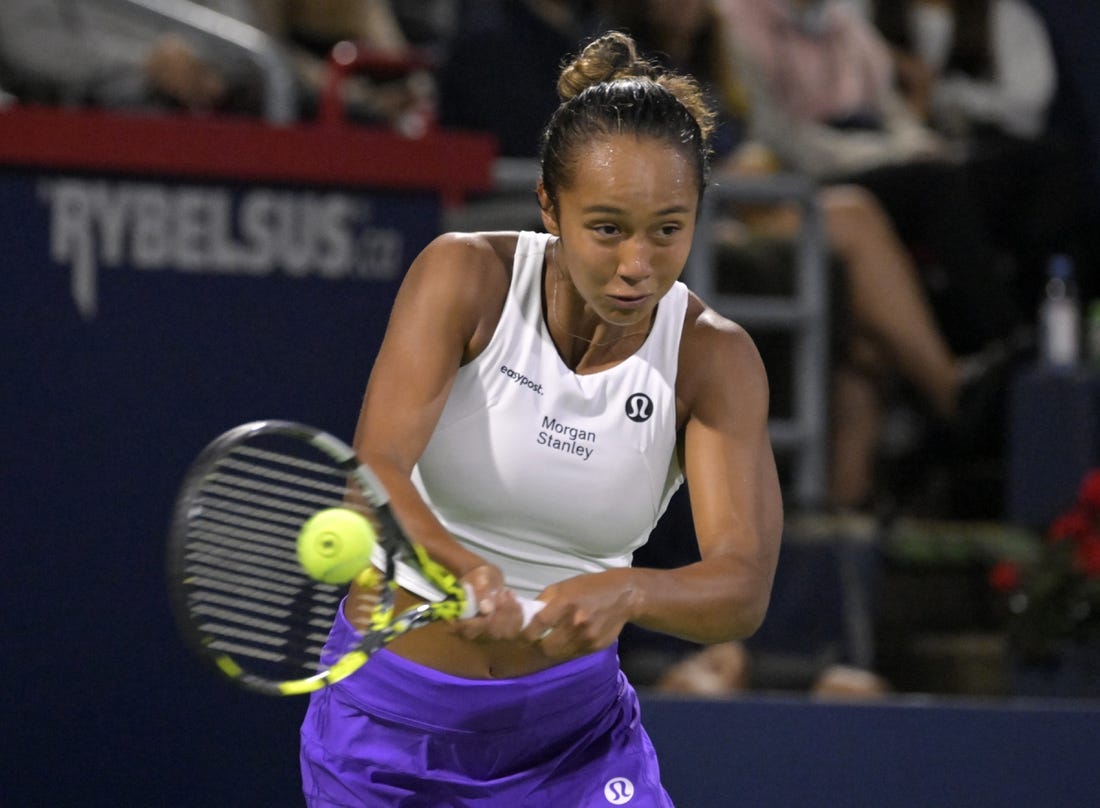 Aug 10, 2023; Montreal, Quebec, Canada; Leylah Fernandez (CAN) hits a backhand against Danielle Collins (USA) (not pictured) during third round play at IGA Stadium. Mandatory Credit: Eric Bolte-USA TODAY Sports