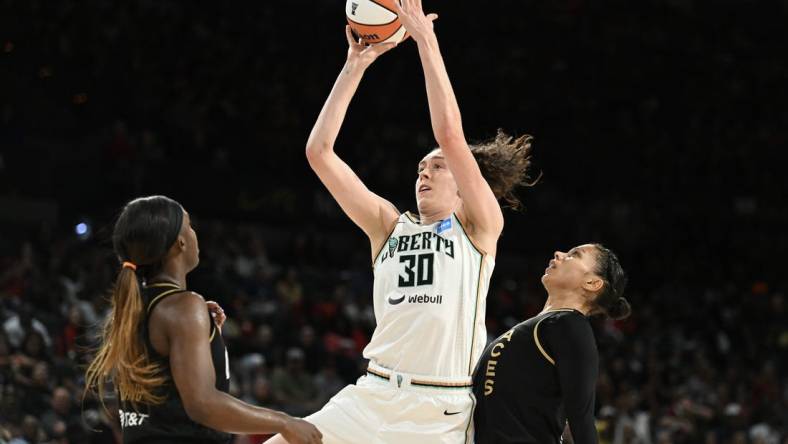 Aug 15, 2023; Las Vegas, Nevada, USA; New York Liberty forward Breanna Stewart (30) takes a shot against Las Vegas Aces guard Jackie Young (0) and forward Alysha Clark (7) during the second quarter at Michelob Ultra Arena. Mandatory Credit: Candice Ward-USA TODAY Sports