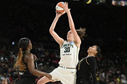 Aug 15, 2023; Las Vegas, Nevada, USA; New York Liberty forward Breanna Stewart (30) takes a shot against Las Vegas Aces guard Jackie Young (0) and forward Alysha Clark (7) during the second quarter at Michelob Ultra Arena. Mandatory Credit: Candice Ward-USA TODAY Sports