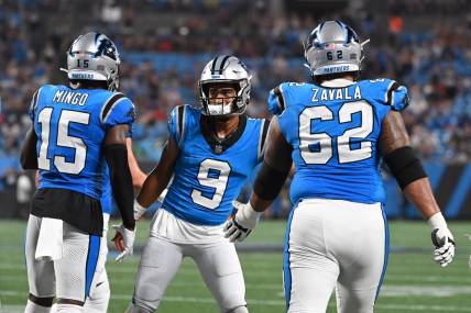 Aug 25, 2023; Charlotte, North Carolina, USA; Carolina Panthers quarterback Bryce Young (9) reacts with wide receiver Jonathan Mingo (15) and guard Chandler Zavala (62) after throwing a touchdown pass in the first quarter at Bank of America Stadium. Mandatory Credit: Bob Donnan-USA TODAY Sports