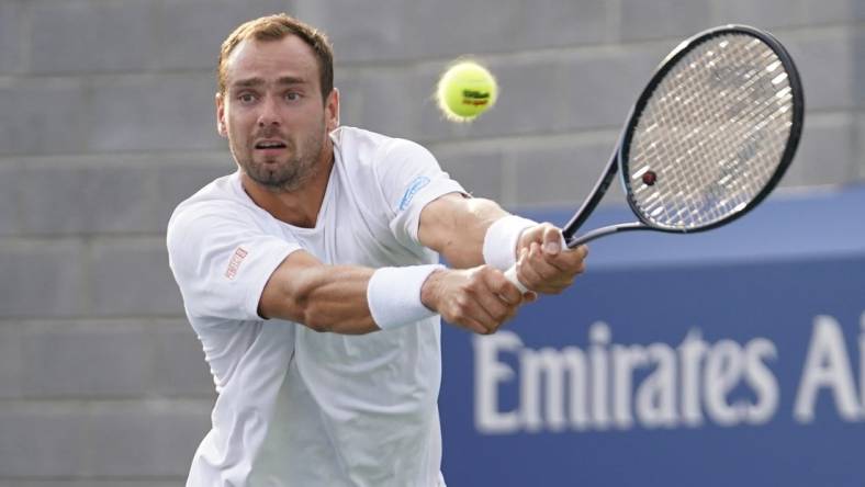 Aug 30, 2023; Flushing, NY, USA; Roman Safiullin hits to Tommy Paul of the United States on day three of the 2023 U.S. Open tennis tournament at USTA Billie Jean King National Tennis Center. Mandatory Credit: Danielle Parhizkaran-USA TODAY Sports