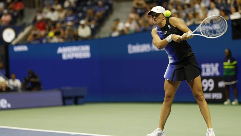 Sep 3, 2023; Flushing, NY, USA; Iga Swiatek of Poland hits a backhand against Jelena Ostapenko of Latvia (not pictured) on day seven of the 2023 U.S. Open tennis tournament at USTA Billie Jean King National Tennis Center. Mandatory Credit: Geoff Burke-USA TODAY Sports