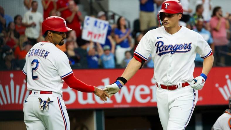 Sep 4, 2023; Arlington, Texas, USA;  Texas Rangers shortstop Corey Seager (5) celebrates with Texas Rangers second baseman Marcus Semien (2) after hitting a two run home run during the first inning against the Houston Astros at Globe Life Field. Mandatory Credit: Kevin Jairaj-USA TODAY Sports