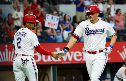 Sep 4, 2023; Arlington, Texas, USA;  Texas Rangers shortstop Corey Seager (5) celebrates with Texas Rangers second baseman Marcus Semien (2) after hitting a two run home run during the first inning against the Houston Astros at Globe Life Field. Mandatory Credit: Kevin Jairaj-USA TODAY Sports