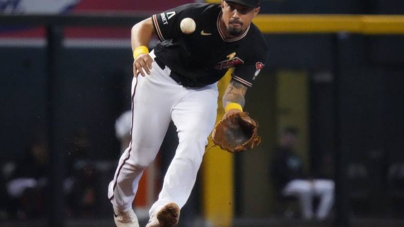 Arizona Diamondbacks' Jace Peterson (6) fields a ground ball at third base against the Baltimore Orioles at Chase Field in Phoenix on Sept. 3, 2023.