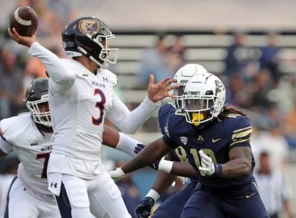 Akron linebacker Antavious Fish closes in on Morgan State quarterback Carson Baker in the first half, Saturday, Sept. 9, 2023.