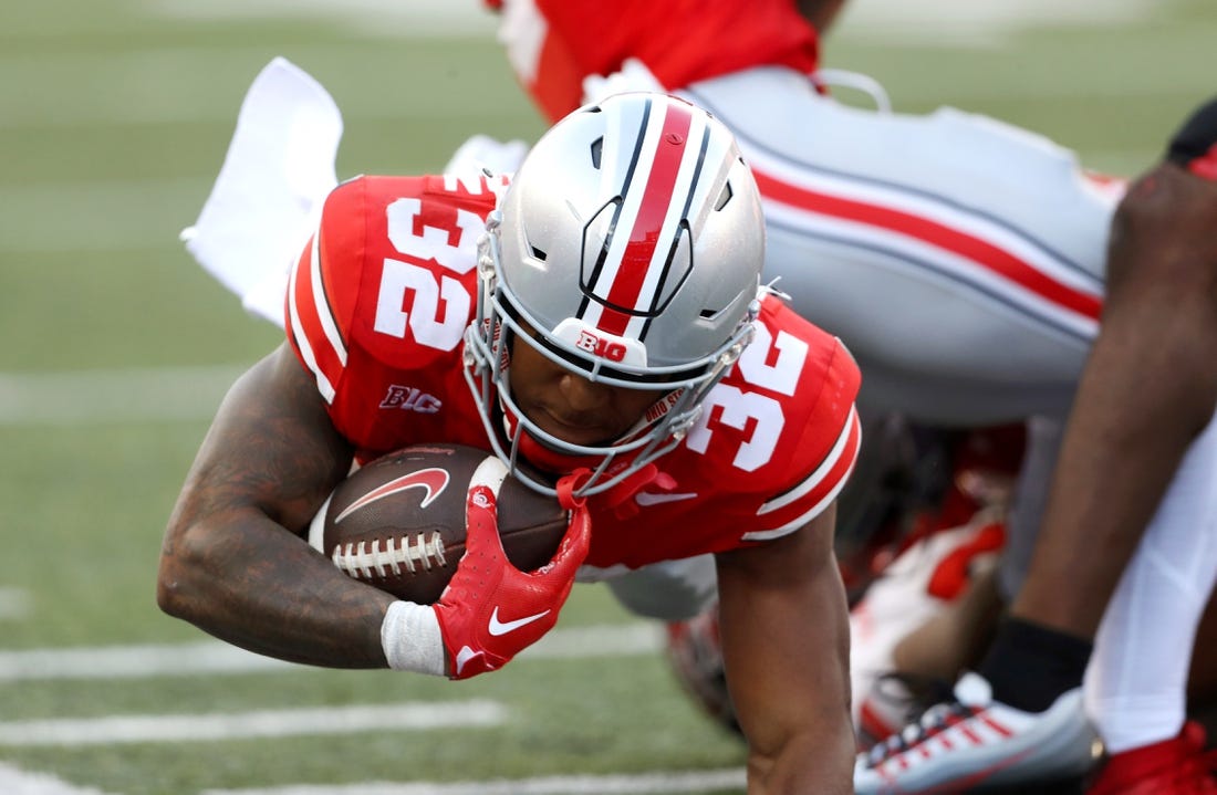 Sep 16, 2023; Columbus, Ohio, USA; Ohio State Buckeyes running back TreVeyon Henderson (32) runs during the second quarter against the Western Kentucky Hilltoppers at Ohio Stadium. Mandatory Credit: Joseph Maiorana-USA TODAY Sports