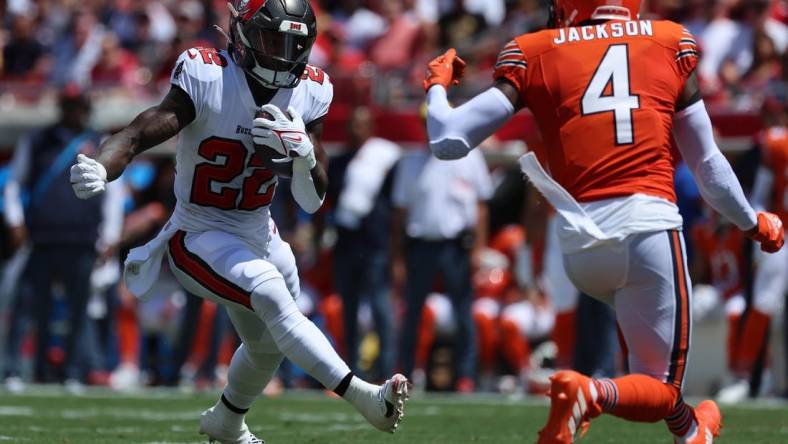 Sep 17, 2023; Tampa, Florida, USA; Tampa Bay Buccaneers running back Chase Edmonds (22) runs with the ball as Chicago Bears safety Eddie Jackson (4) defends during the first quarter at Raymond James Stadium. Mandatory Credit: Kim Klement Neitzel-USA TODAY Sports